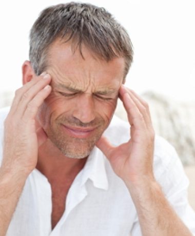 Man having a headache at home